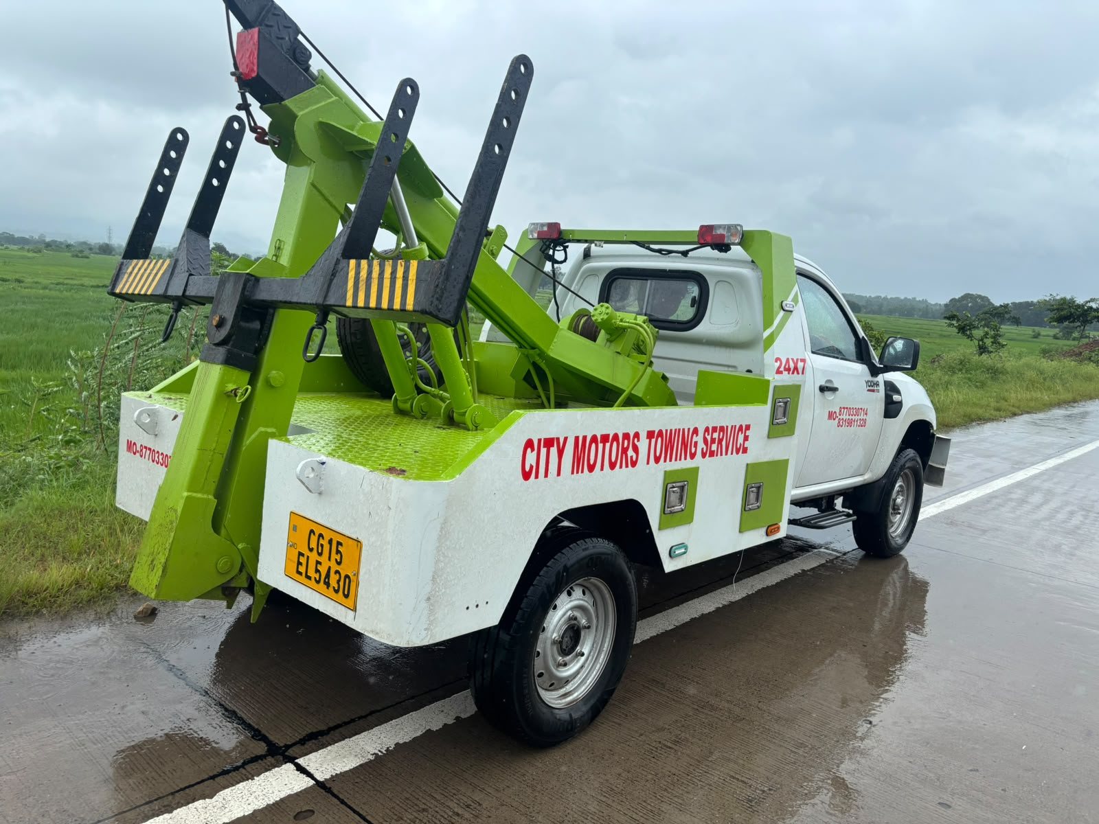 City Motors towing truck with recovery equipment on a road